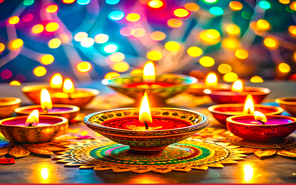 Brightly coloured candles lit for Diwali. There are eight candles, and bokeh lights surrounding them.