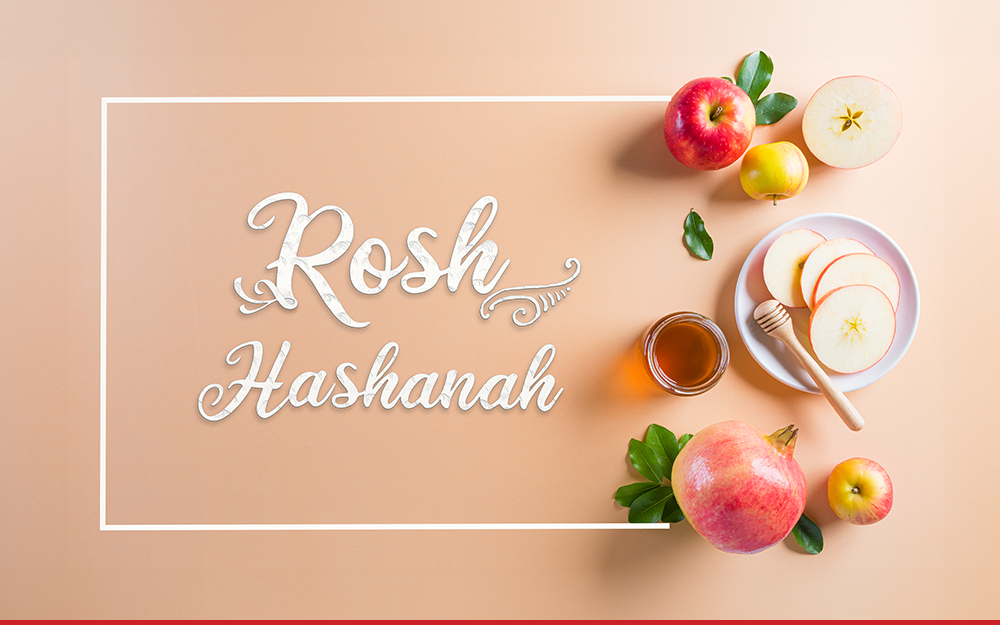 A neutral background with text that says "Rosh Hashanah". There are various fruits to the right of the text.