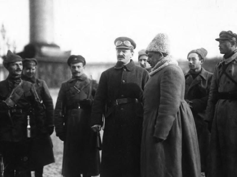 Black and white photograph of several men dressed in military attire, with one in a heavy coat.