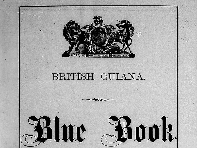Section of the front cover of the Blue Book, featuring a coat of arms and the text British Guiana.