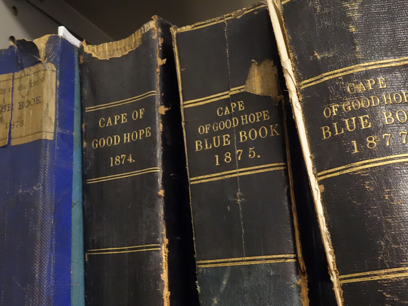 A close-up photograph of four bound blue books.