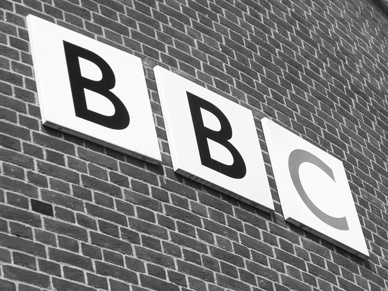 The BBC logo displayed on the side of a brick wall