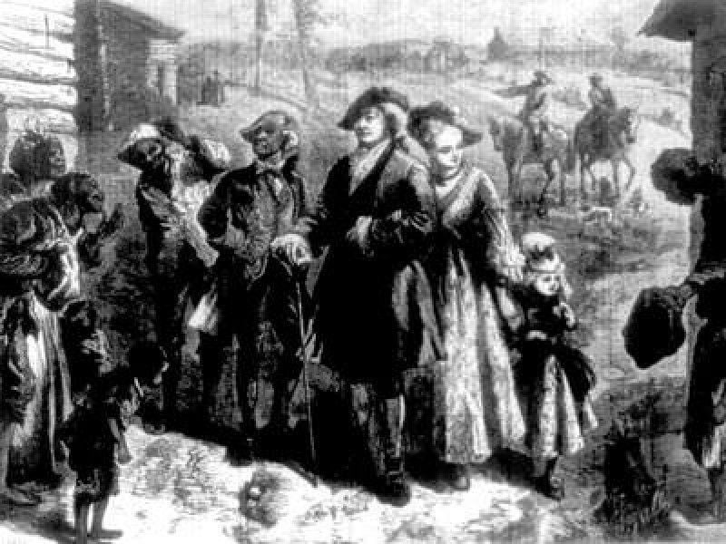 A well-dressed plantation owner and family visiting the slave quarters in Virginia