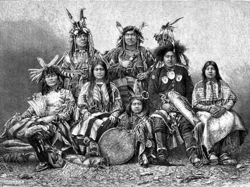 Native American warriors and their wives, arranged for a group sitting.