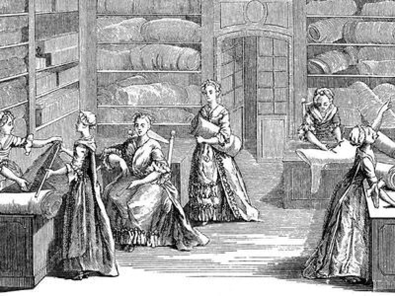 An engraving of seven women working in a fabric shop, 1885.