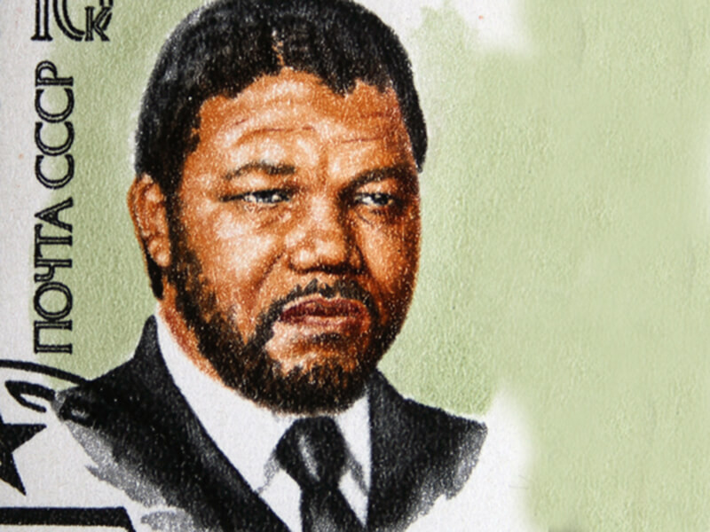 A Stamp printed by Russia features a portrait of Nelson Mandela on a green background