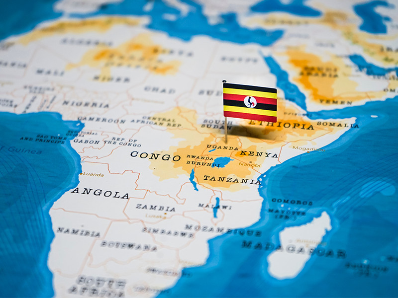 The Flag of Uganda protruding from the country on a world map.