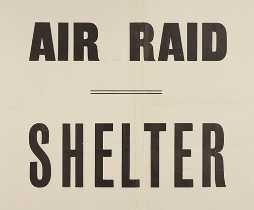 An aged piece of paper with Air Raid Shelter written across it in capital letters.
