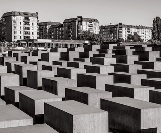 A black and white photograph of the Memorial to the Murdered Jews of Europe in Berlin.