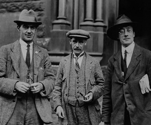 A black and white photo of three men.