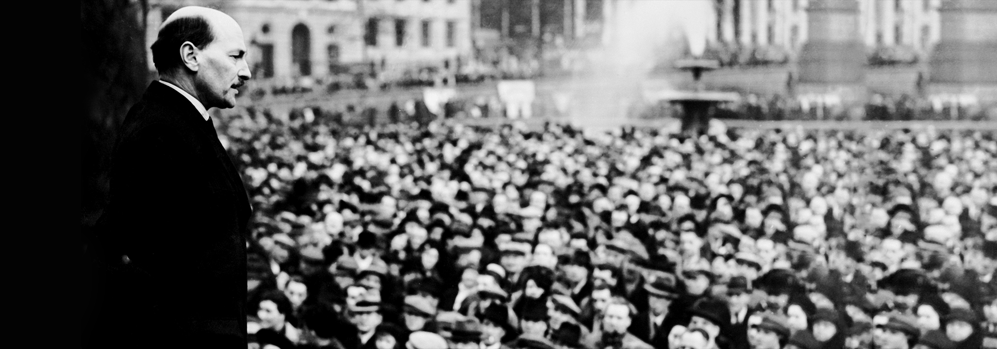A black and white image of Clement Attlee addressing a crowd shortly after leading Labour to victory.
