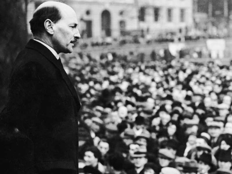 A black and white image of Clement Attlee addressing a crowd shortly after leading Labour to victory.