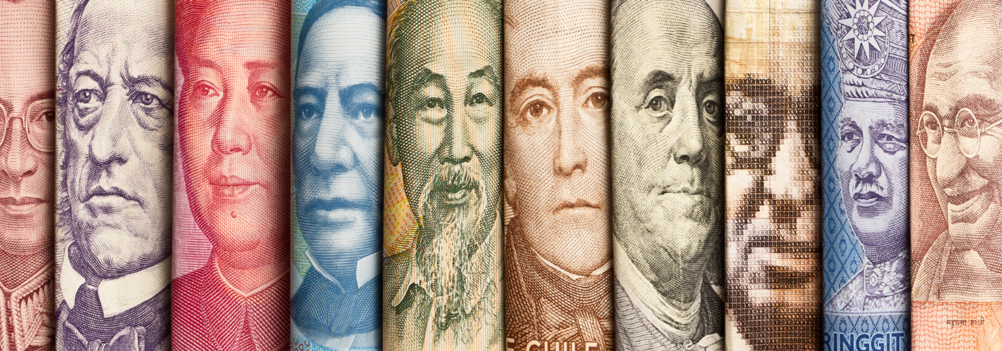 A composite still life of various international currencies, featuring faces of world leaders past and present.