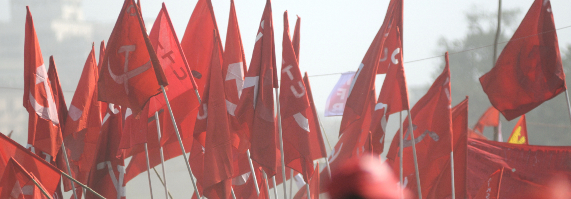 An image of lots of Communist flags, held up by a group of people.