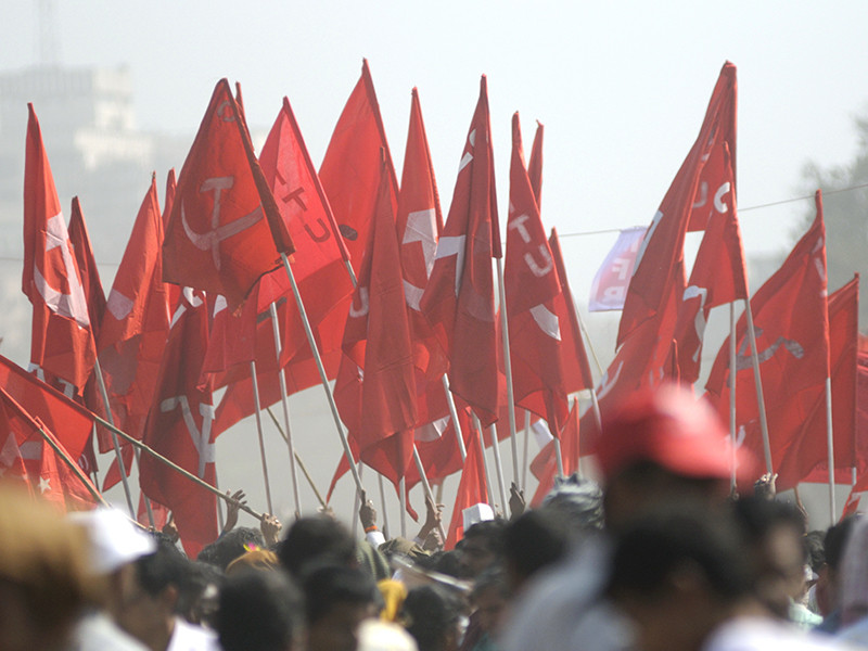 An image of lots of Communist flags, held up by a group of people.
