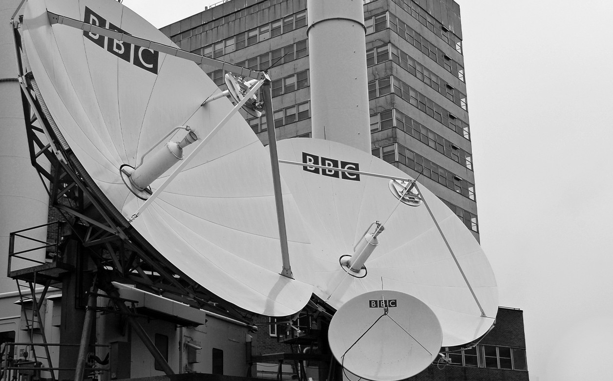 Image of three radio satellite dishes with BBC logos on.