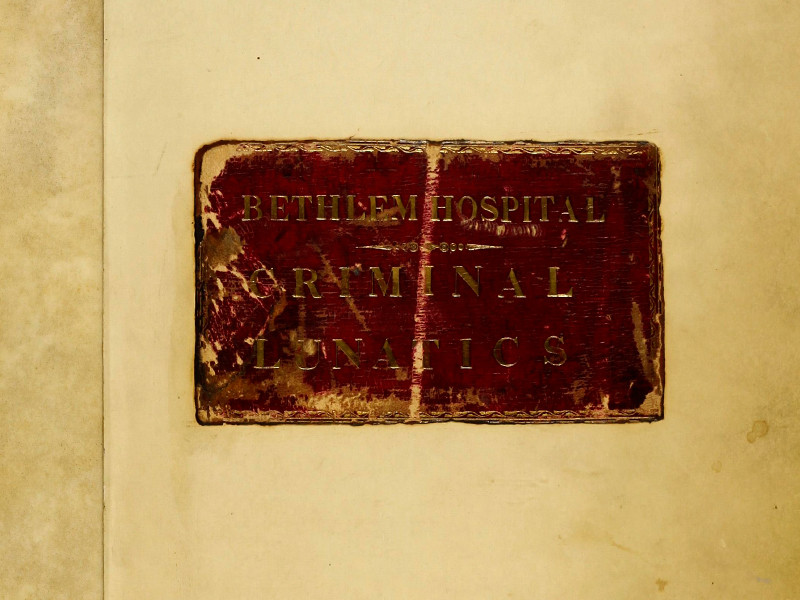 Section of the cover of a casebook, featuring a plate reading Bethlem Hospital Criminal Lunatics.