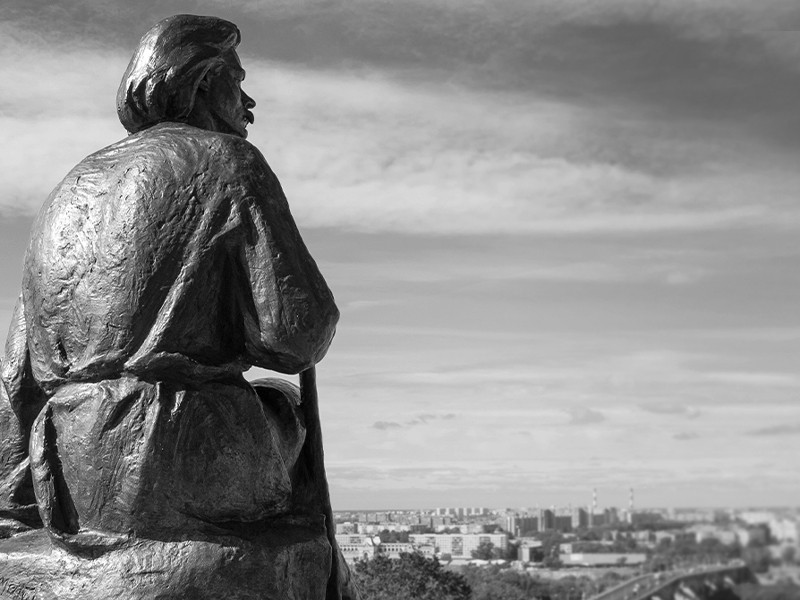 The monument to the Soviet writer Maxim Gorky. The statue is of Maxim Gorky sat down holding a walking stick.