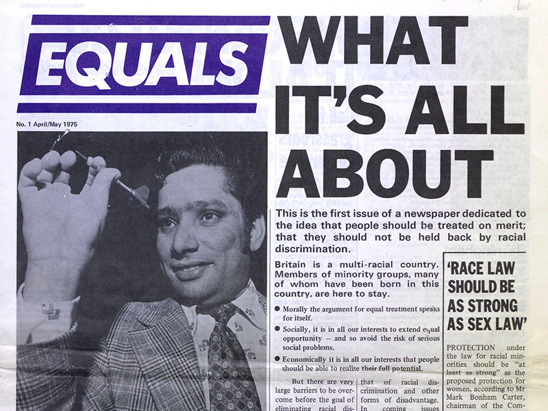 Front page of the first issue of Equals, featuring an article titled What It's All About and a photograph of a man playing darts.