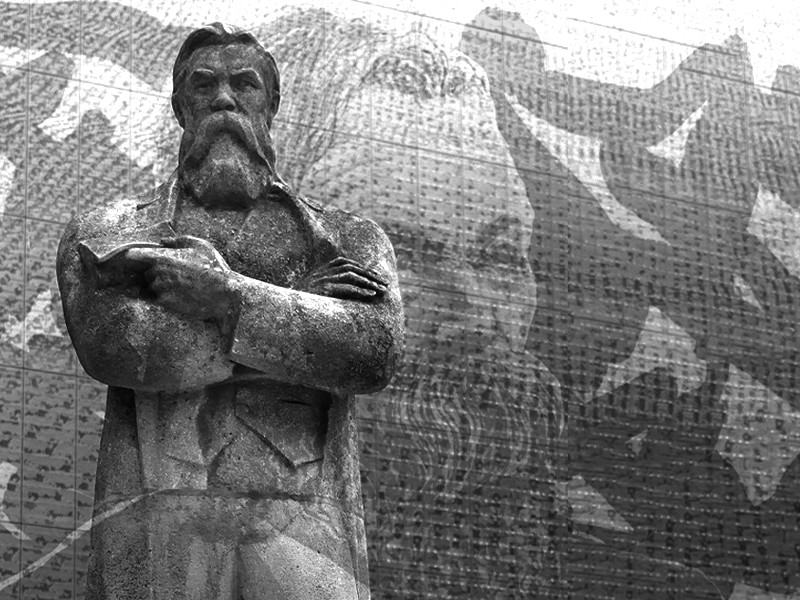 A black and white photo of the Friedrich Engels statue in Manchester.