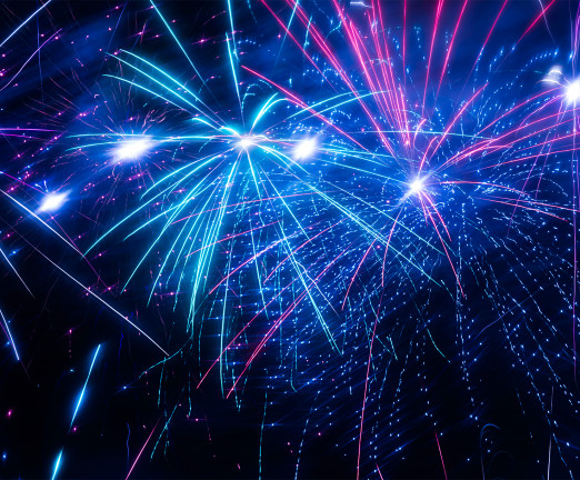 Blue, purple and pink fireworks exploding against a dark sky.