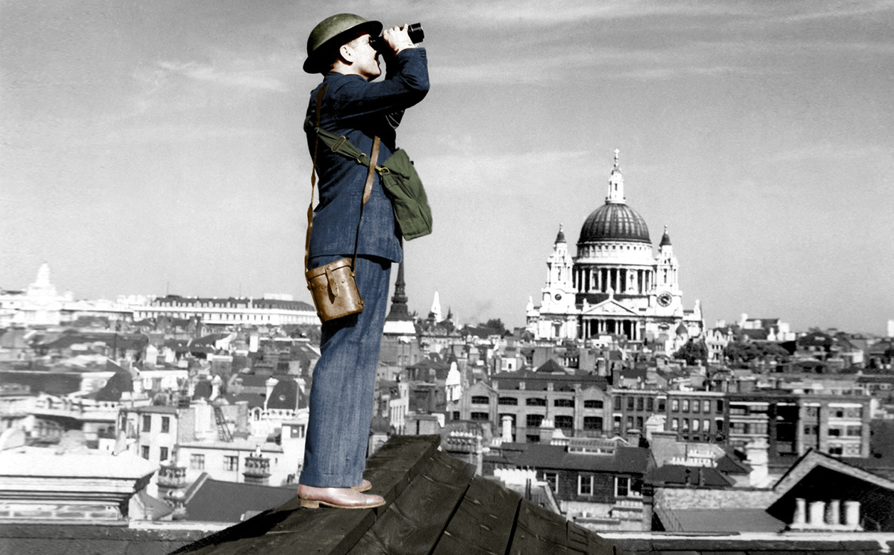 An image of an aircraft spotter searching the sky with binoculars during the Battle of Britain, World War 2. St. Paul's Cathedral is in the background.