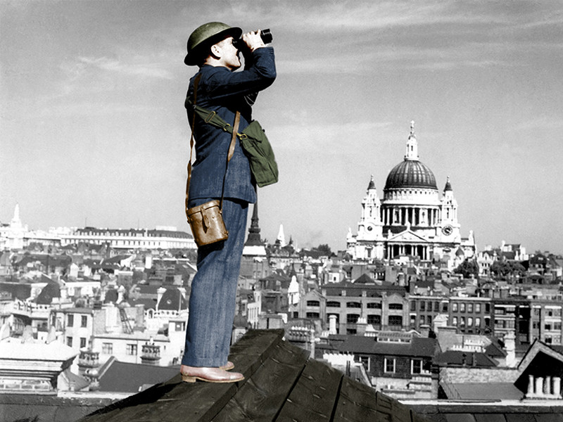 An image of an aircraft spotter searching the sky with binoculars during the Battle of Britain, World War 2. St. Paul's Cathedral is in the background.
