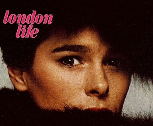 A photograph of Geraldine Chaplin, actress, with pink letters that read 'london life'. Only her face is visible, and her mouth and eye are partially covered by black fur.