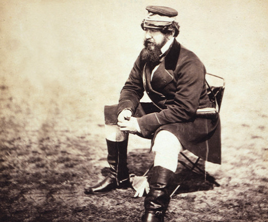 A photograph of William Howard Russell. He is seated, looking in to the distance.