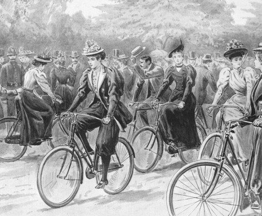 An illustration showing women cycling. They wear long skirts.