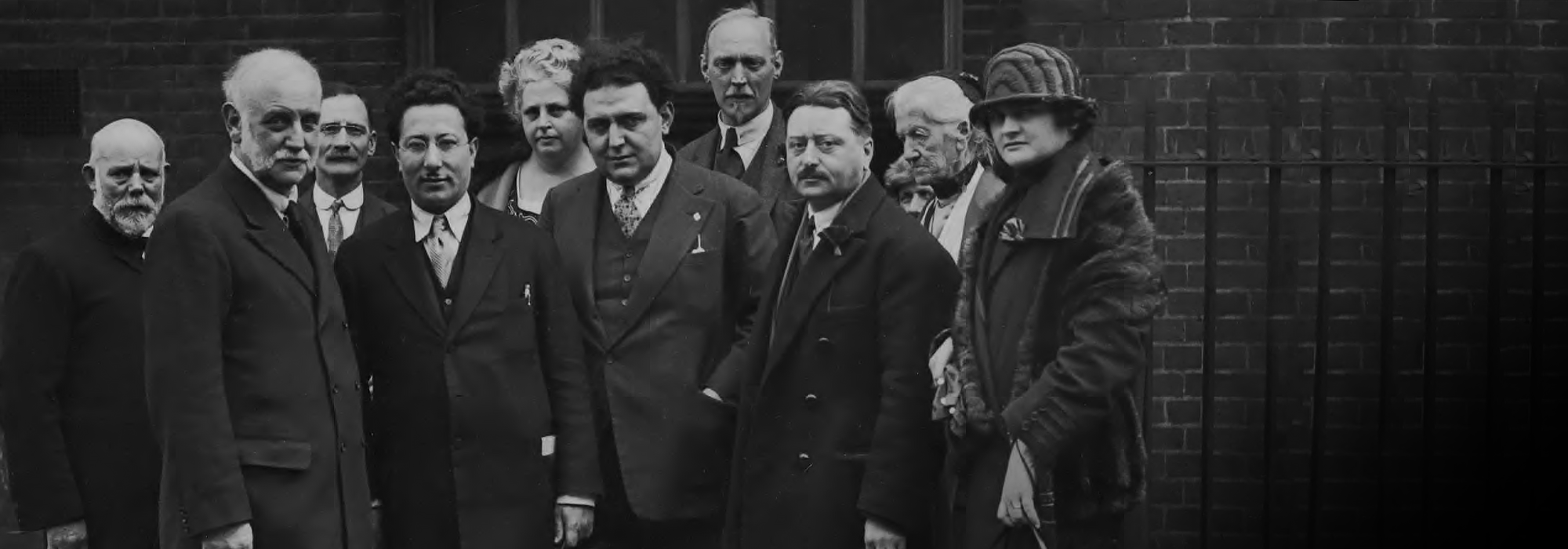 A black and white image of ten people looking at the camera.
