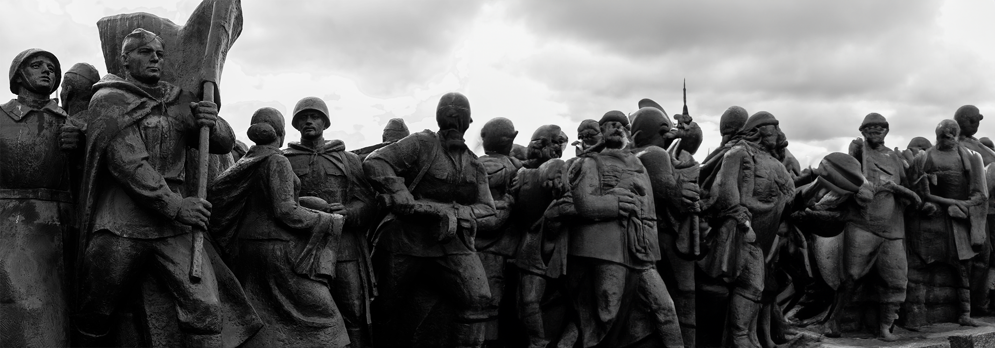 A black and white image of a statue of various men.