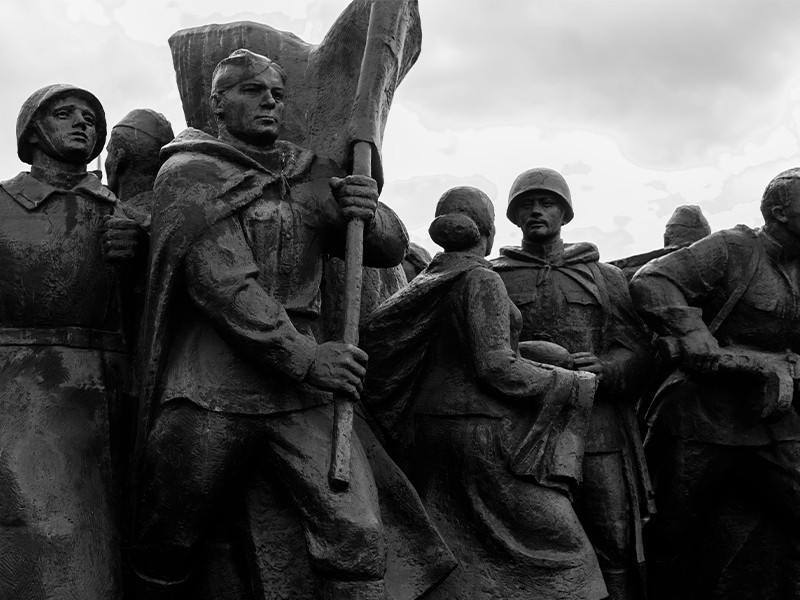 A black and white image of a statue of various men.