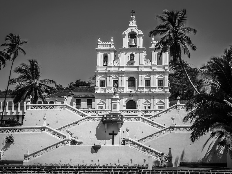 Our Lady of Immaculate Conception Church, Goa, pictured with palm trees.
