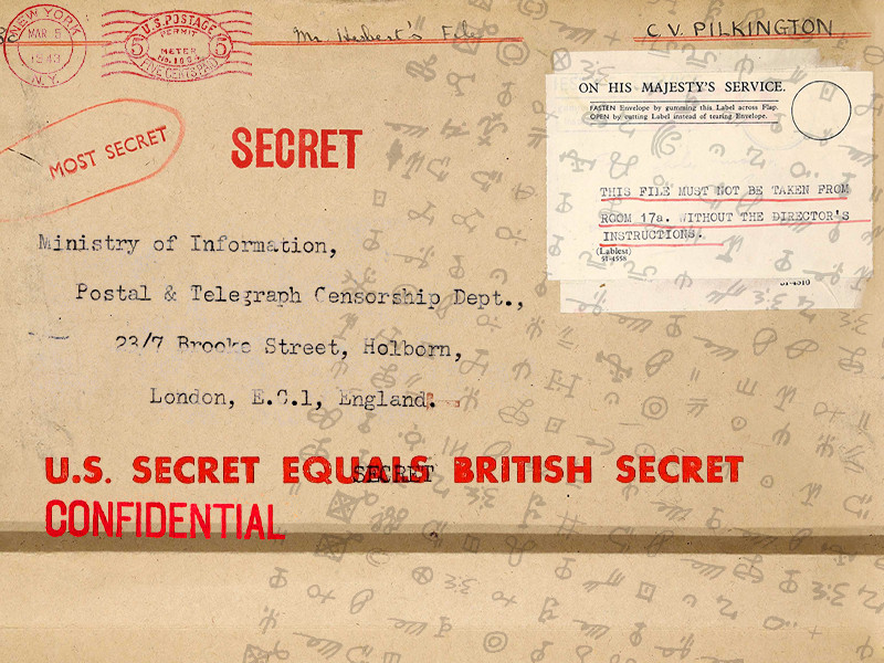 Beige background with red and black lettering. There is a letter header to the Ministry of Information, stamped with a red SECRET stamp. Underneath it reads U.S. Secret Equals British Secret Confidential. Over the top of the image are various symbols depicting a code language.
