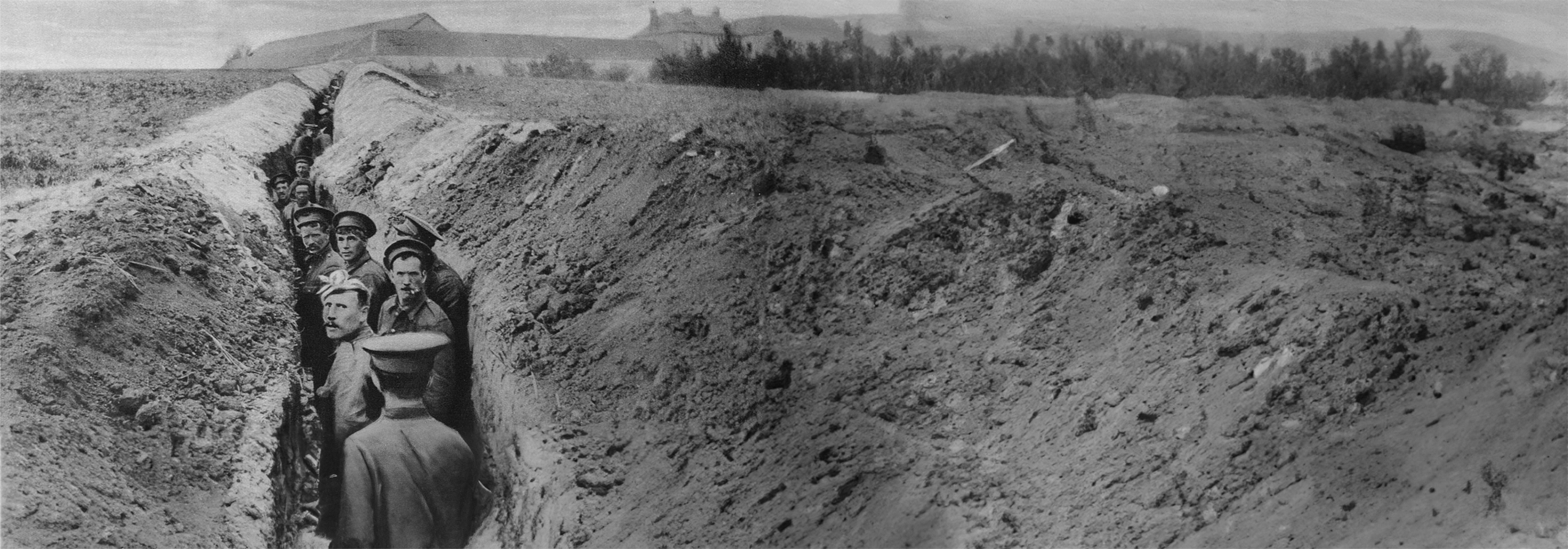 A black and white image of First World War troops standing in a trench.