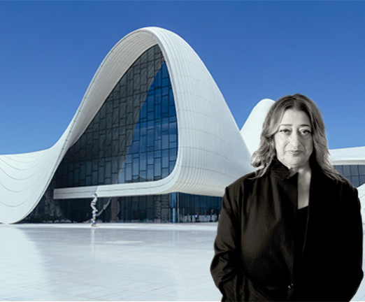 A photograph of Zaha Hadid in front of one of her buildings.