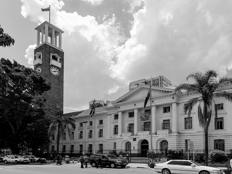A greyscale photograph of the front of the Nairobi city hall, capital of Kenya.
