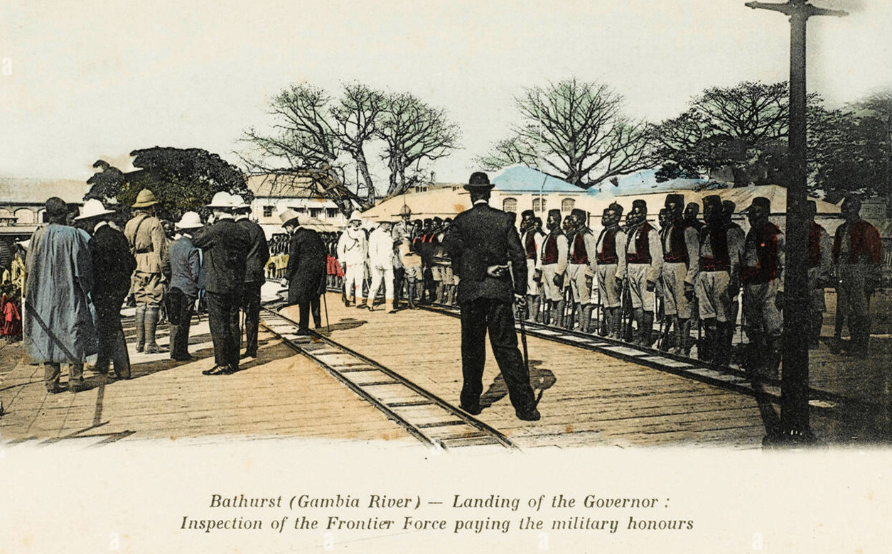 The landing of the British Governor at Bathurst, Gambia River: His inspection of the Frontier Force who are paying the military honours.