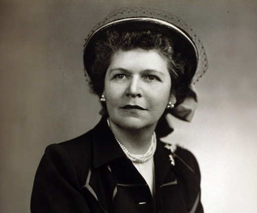 A black and white photograph of Georgia Neese Clark, a woman wearing a smart hat and blazer.