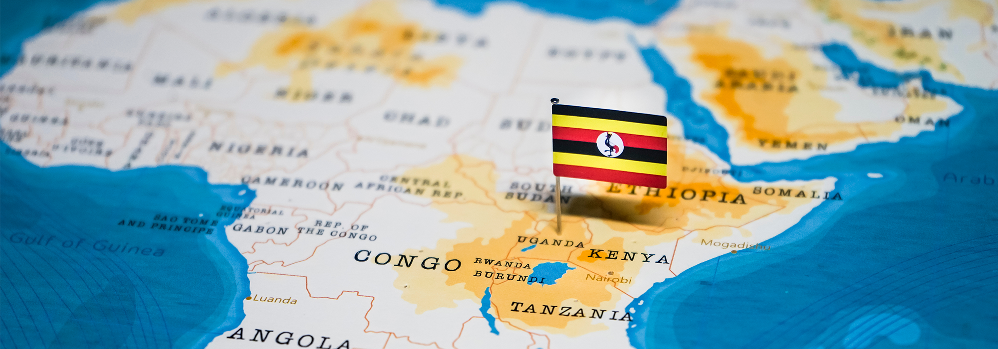 The Flag of Uganda protruding from the country on a world map.