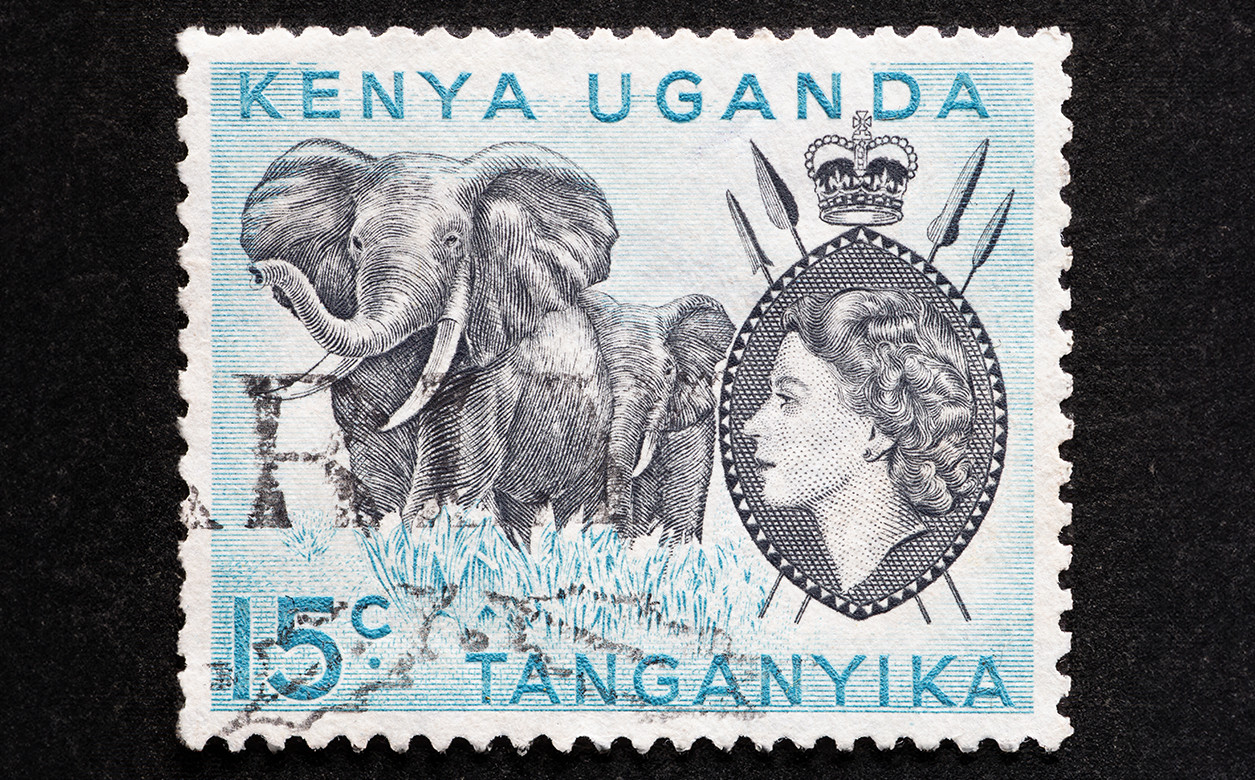 A stamp with an image of the queen and two elephants. Typed on the stamp are the countries Kenya, Uganda, and Tanganyika.