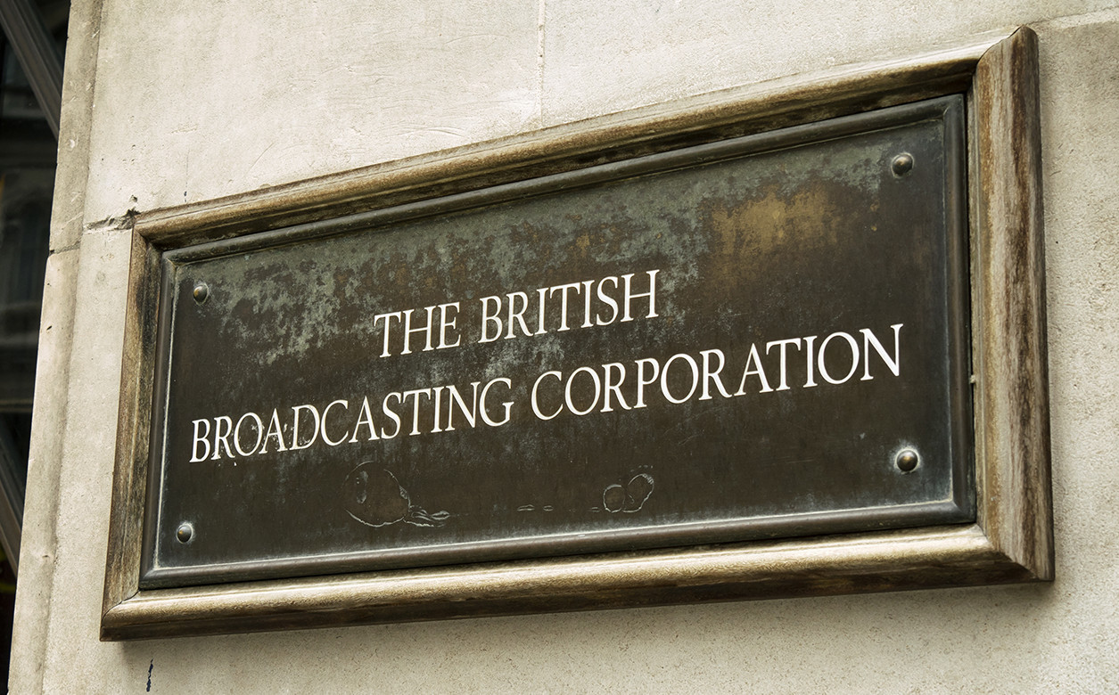 An old-fashioned metal plaque outside Broadcasting House, home of the British Broadcasting Corporation (the BBC) in Langham Place, Central London.