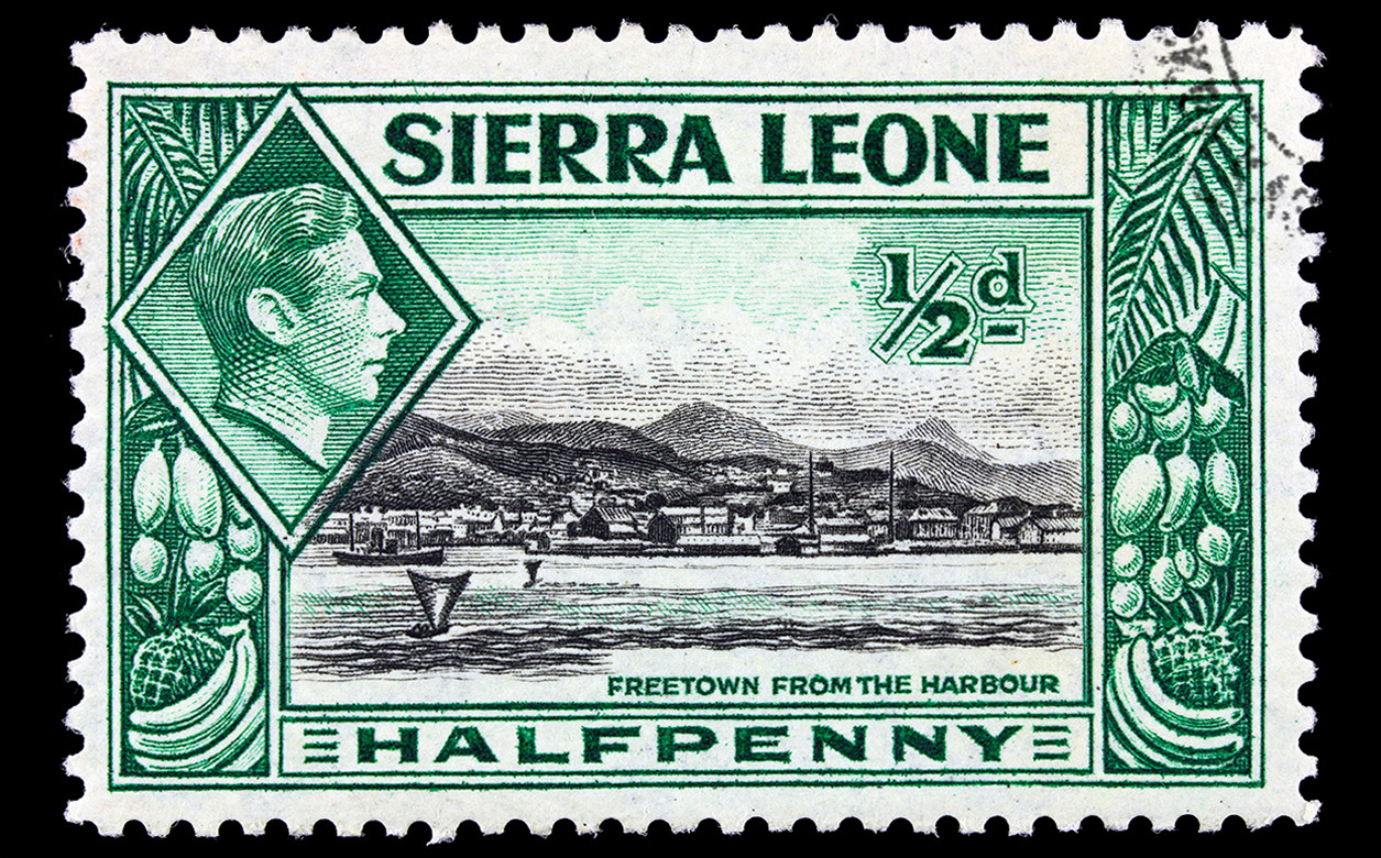 A stamp depicting a city scene and an inset of King George VI, with inscription Freetown from the Harbour, circa 1940.