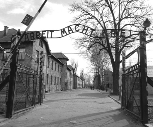 ntrance gate to the Auschwitz concentration camp, with the infamous slogan Arbeit macht frei above it.