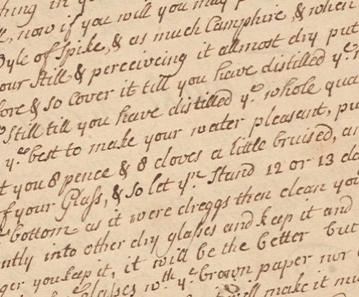 An aged piece of paper with cursive script written on a slant across the page.